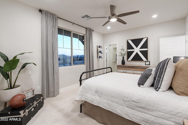 bedroom featuring light colored carpet and ceiling fan