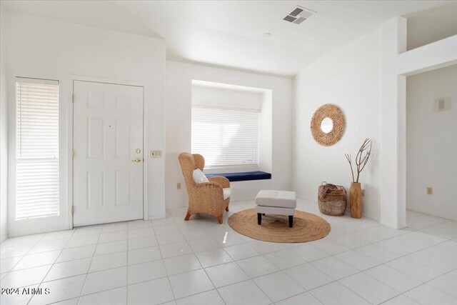 living area with a wealth of natural light and light tile patterned floors