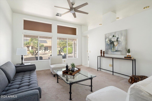 carpeted living room with ceiling fan