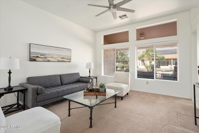 carpeted living room with ceiling fan