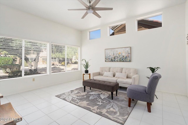 living room with high vaulted ceiling, ceiling fan, and light tile patterned flooring