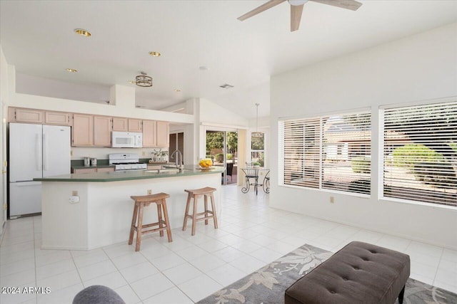 kitchen with lofted ceiling, light tile patterned floors, ceiling fan, light brown cabinets, and white appliances