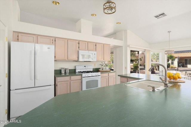 kitchen featuring light brown cabinets, white appliances, sink, and lofted ceiling