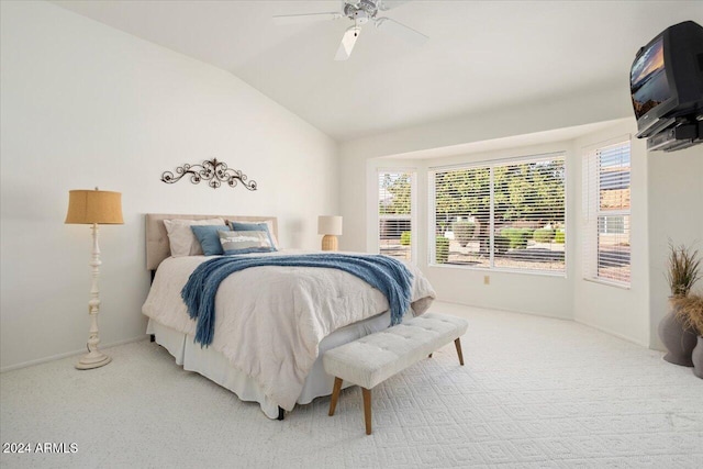 carpeted bedroom with ceiling fan and vaulted ceiling