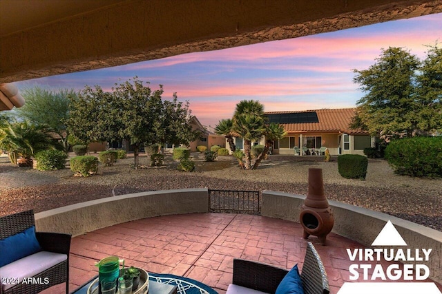 view of patio terrace at dusk