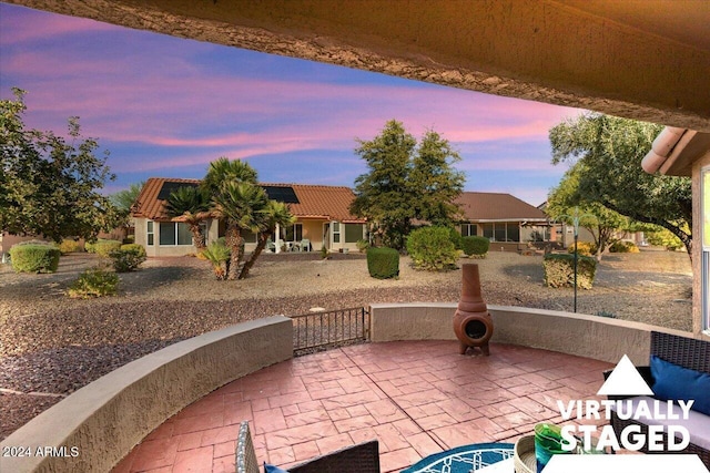 view of patio terrace at dusk