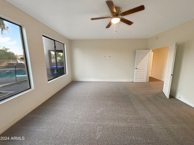 carpeted spare room with ceiling fan