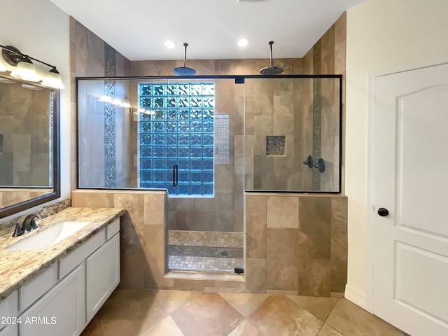 bathroom with walk in shower, tile floors, and vanity