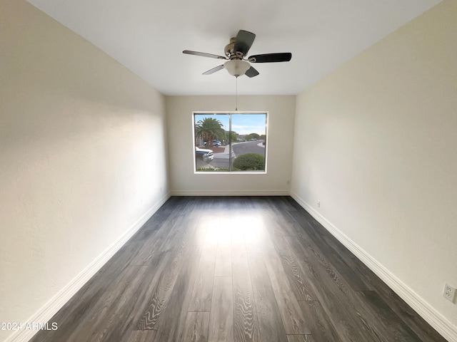 spare room with ceiling fan and dark hardwood / wood-style flooring