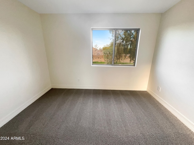 empty room featuring dark carpet