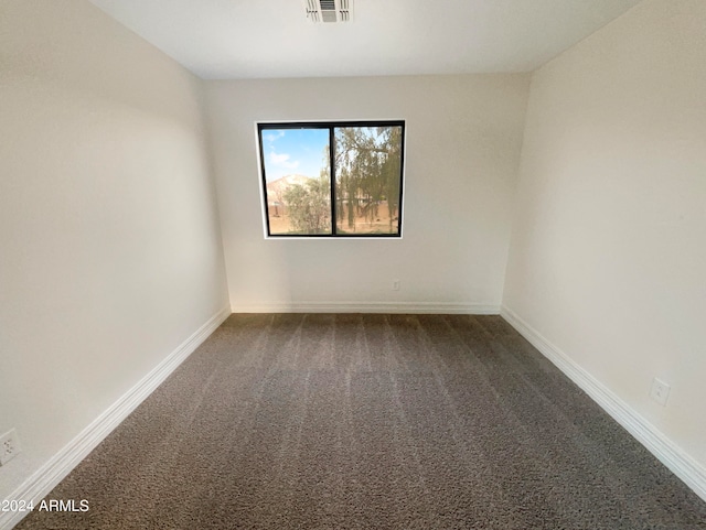 empty room with dark carpet