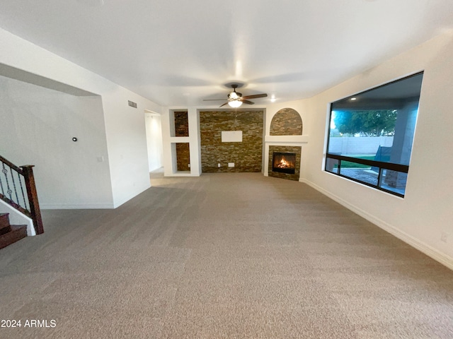 unfurnished living room featuring carpet floors and ceiling fan