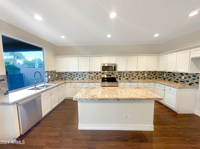 kitchen featuring white cabinets, tasteful backsplash, stainless steel appliances, and dark hardwood / wood-style flooring