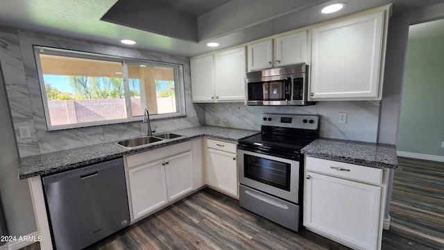 kitchen featuring white cabinets, appliances with stainless steel finishes, sink, and dark hardwood / wood-style flooring