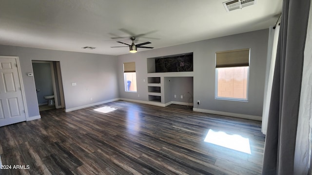 unfurnished living room with ceiling fan and dark hardwood / wood-style floors