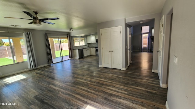 unfurnished living room featuring ceiling fan and dark hardwood / wood-style floors