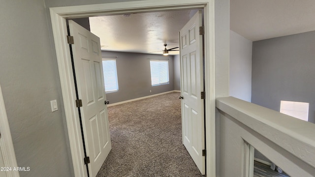 hallway with dark carpet