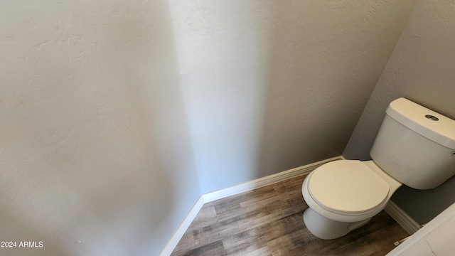 bathroom featuring toilet and hardwood / wood-style flooring