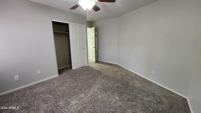 unfurnished bedroom featuring ceiling fan, dark colored carpet, and a closet