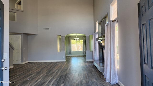 interior space with a high ceiling and dark hardwood / wood-style flooring