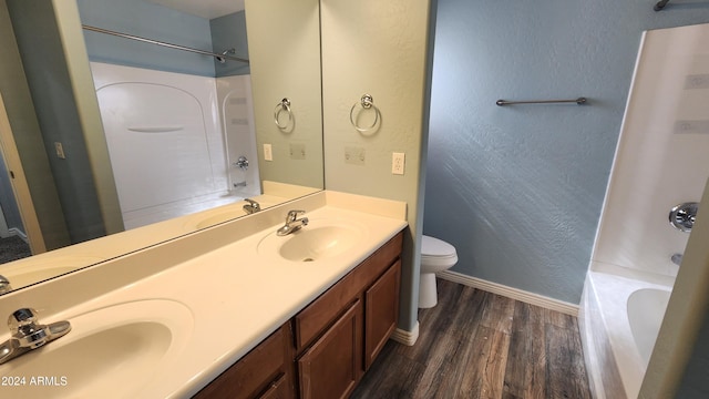 bathroom featuring wood-type flooring, vanity, and toilet