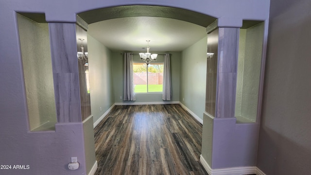 interior space featuring dark hardwood / wood-style floors and a chandelier