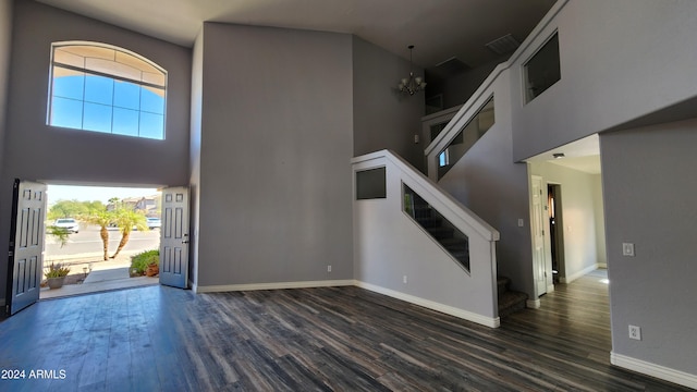 foyer featuring a high ceiling, an inviting chandelier, and dark hardwood / wood-style floors