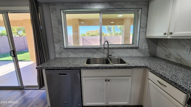 kitchen featuring white cabinetry, stainless steel dishwasher, a wealth of natural light, and sink