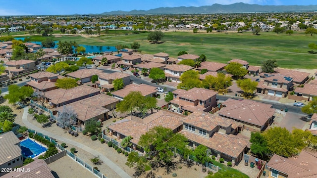 birds eye view of property featuring golf course view, a residential view, and a water and mountain view