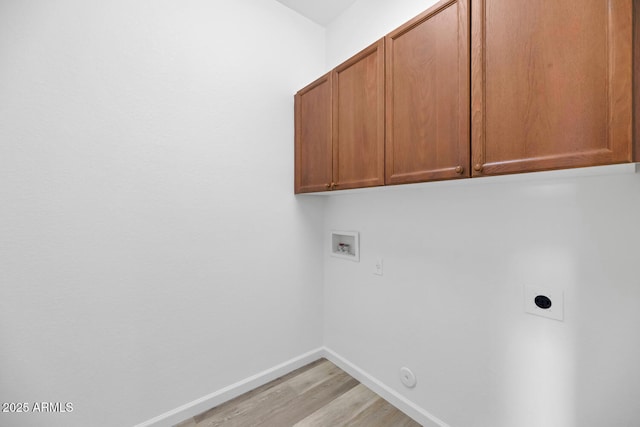 laundry area with hookup for a washing machine, baseboards, hookup for an electric dryer, cabinet space, and light wood-style floors