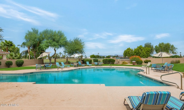 pool featuring fence and a patio area