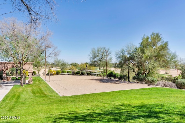 surrounding community featuring a lawn and volleyball court