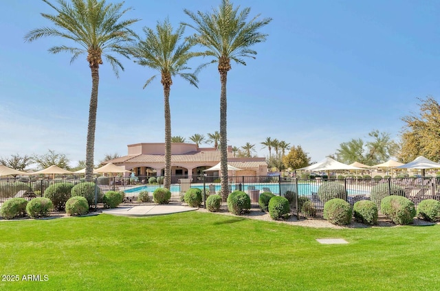 view of yard with a community pool and fence