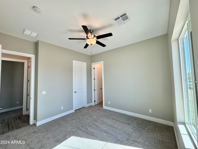 unfurnished bedroom featuring ceiling fan and carpet floors