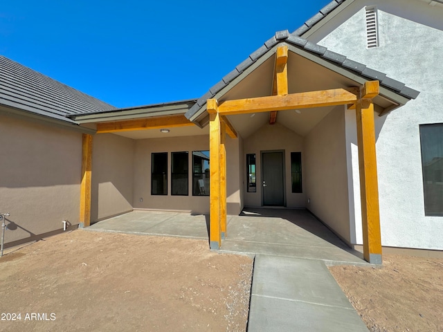 back of property featuring a patio area