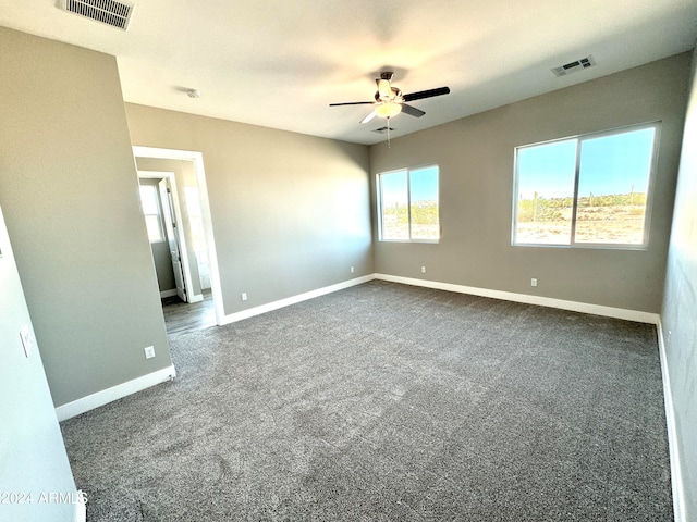 carpeted spare room with ceiling fan