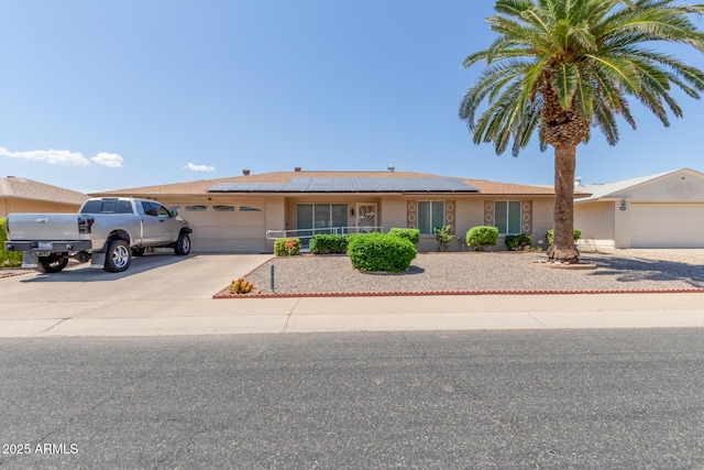 view of front of home featuring a garage and solar panels