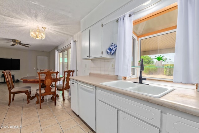 kitchen with white cabinets, dishwasher, sink, decorative light fixtures, and ceiling fan with notable chandelier