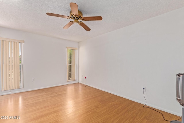 unfurnished room with a textured ceiling, ceiling fan, and light hardwood / wood-style flooring