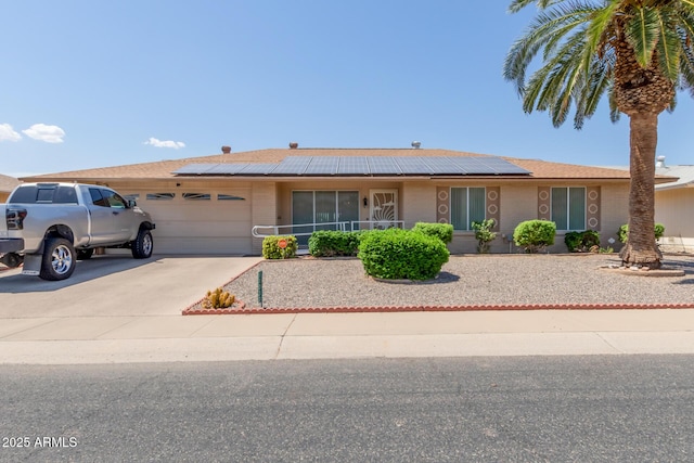 single story home featuring a garage and solar panels