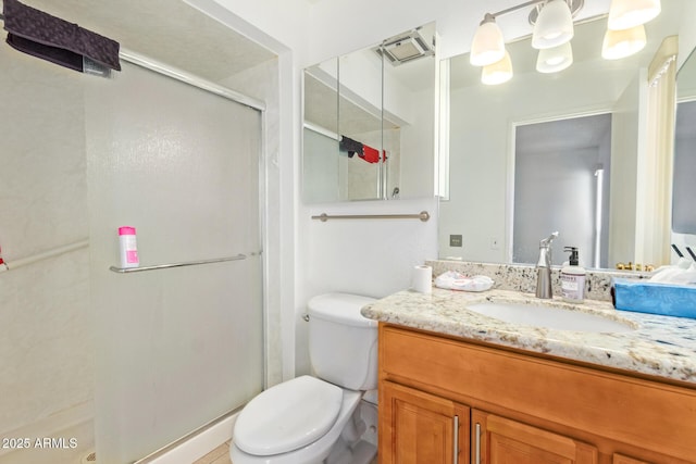 bathroom featuring an enclosed shower, vanity, and toilet