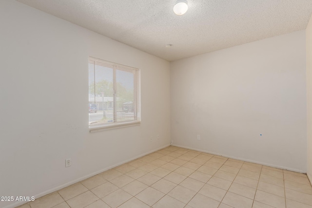 5933 W Mitchell Dr, Phoenix, AZ 85033 - empty room with a textured ceiling and light tile patterned flooring
