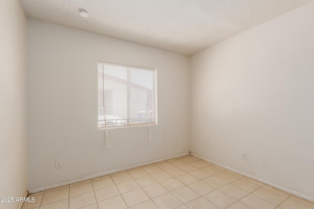 5933 W Mitchell Dr, Phoenix, AZ 85033 - empty room featuring a textured ceiling and light tile patterned floors