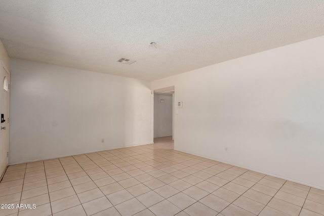 5933 W Mitchell Dr, Phoenix, AZ 85033 - unfurnished room featuring a textured ceiling and light tile patterned floors