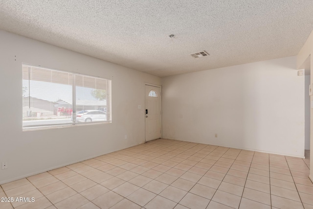 5933 W Mitchell Dr, Phoenix, AZ 85033 - spare room featuring a textured ceiling