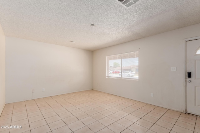 5933 W Mitchell Dr, Phoenix, AZ 85033 - unfurnished room with a textured ceiling and light tile patterned floors