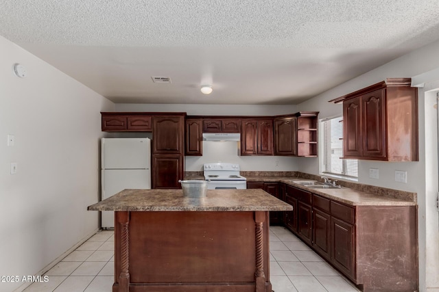 5933 W Mitchell Dr, Phoenix, AZ 85033 - kitchen with white appliances, under cabinet range hood, open shelves, light tile patterned floors, and a textured ceiling