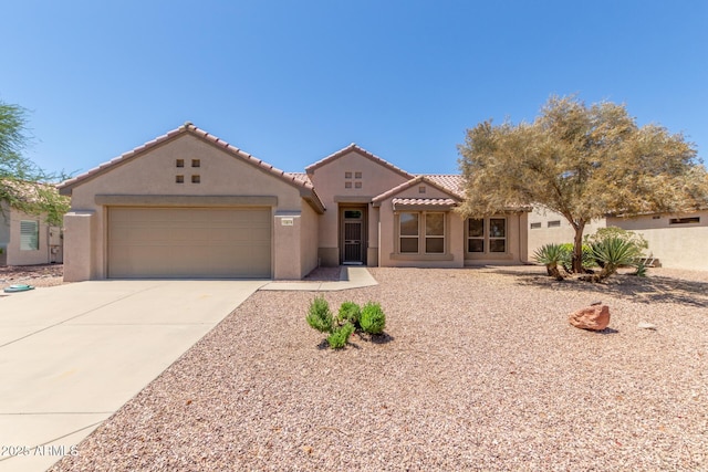 15874 W Wildflower Dr, Surprise, AZ 85374 - mediterranean / spanish house featuring stucco siding, concrete driveway, a garage, and a tile roof