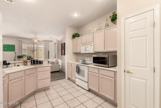 15874 W Wildflower Dr, Surprise, AZ 85374 - kitchen with white appliances, light tile patterned floors, ceiling fan, light countertops, and recessed lighting