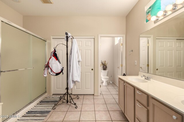 15874 W Wildflower Dr, Surprise, AZ 85374 - bathroom with a stall shower, tile patterned flooring, and double vanity
